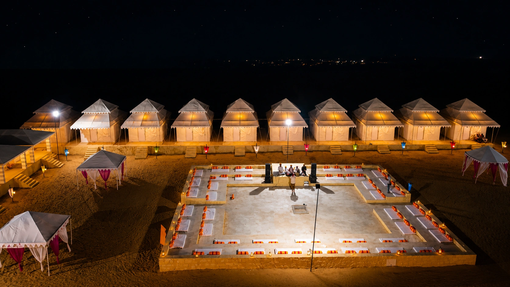Desert camp with tents at dusk